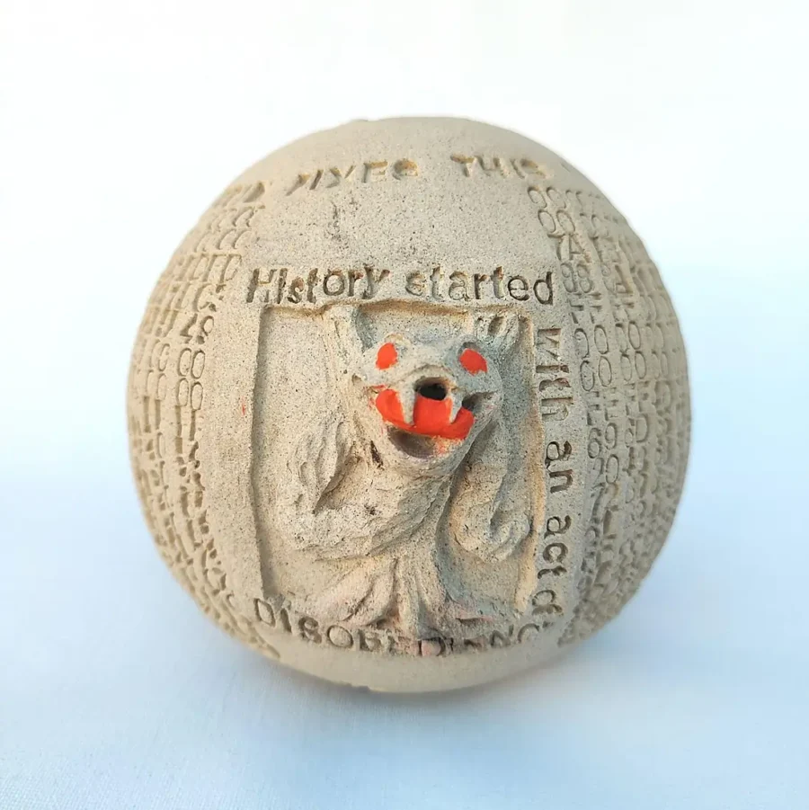 Yonat Vaks Bulla clay artwork featuring a snake relief with the inscription 'History started with an act of disobedience', Bitcoin Genesis Block hex code circling the surface.